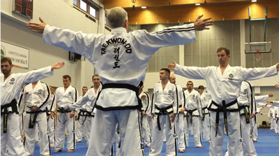 Taekwon-Do class performing safe warm-up exercises