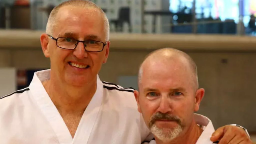 Taekwon-Do Masters performing techniques during an 8th degree black belt grading