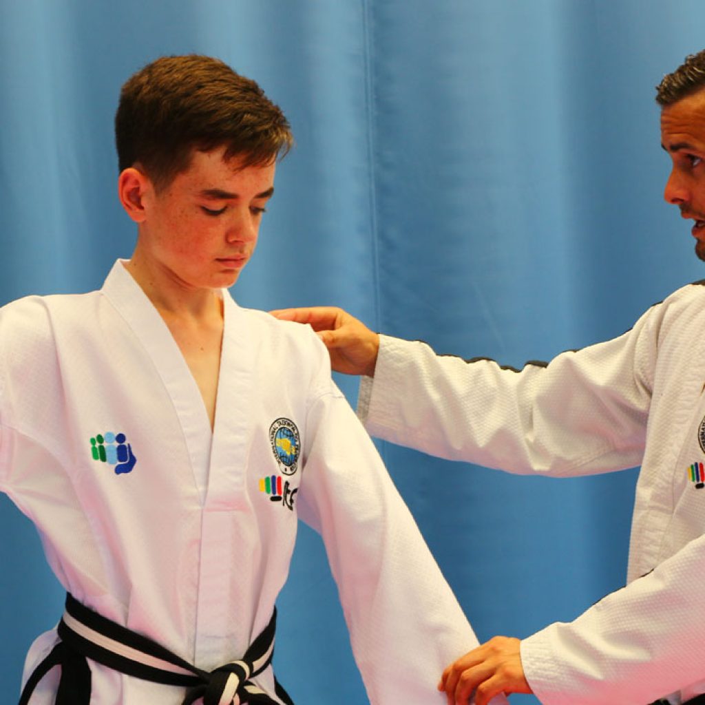 Master Mark Trotter coaching Toi-Gye pattern movements during a training session.