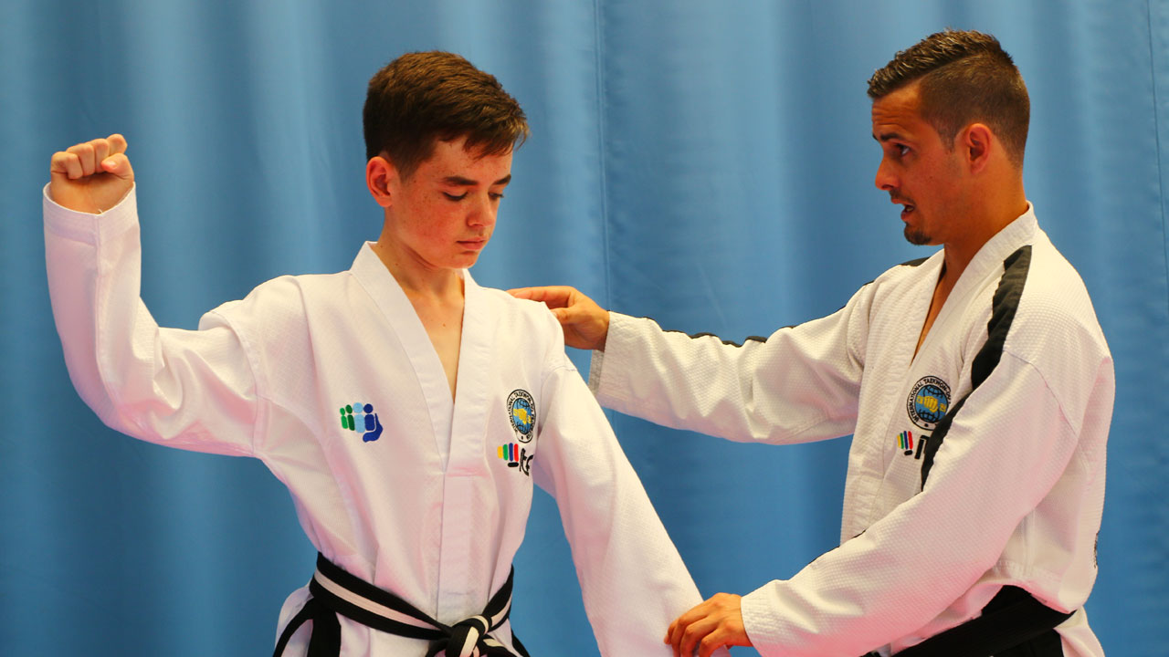 Master Mark Trotter coaching Toi-Gye pattern movements during a training session.