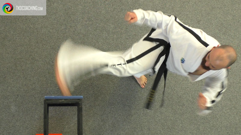 Taekwon-Do practitioner demonstrating correct angle and trajectory during a power breaking kick