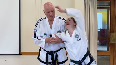 Control and restraint techniques demonstrated in a self-defence training session