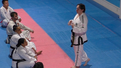 Master Matthew Breen explaining General Choi’s training secrets to Taekwon-Do students during a technical class